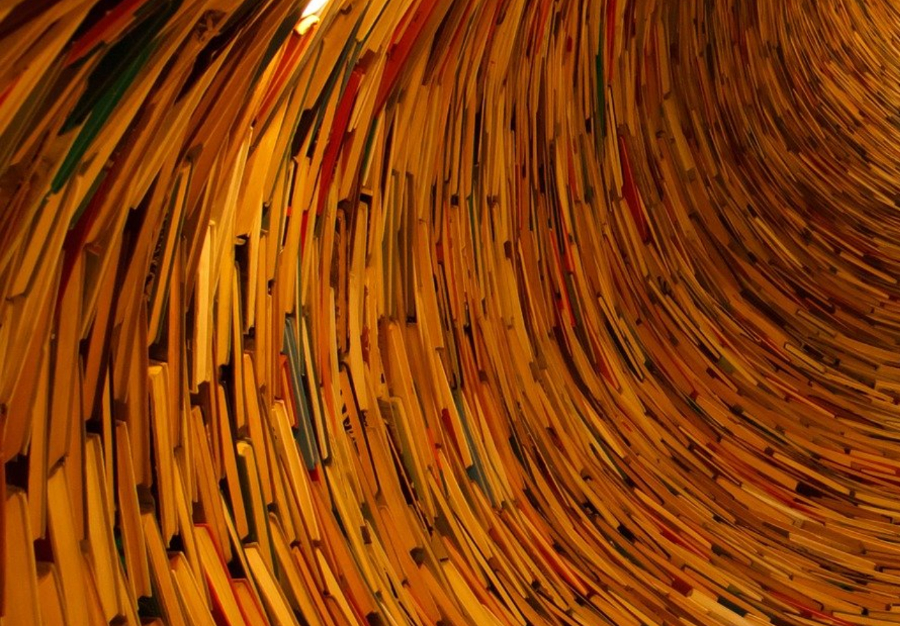 Hundreds of books swirl upwards